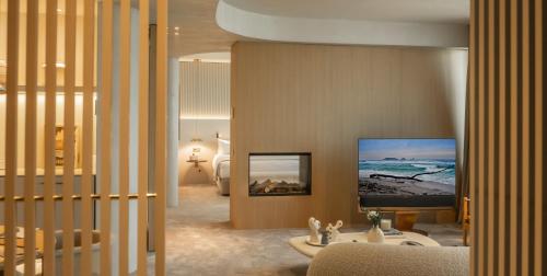 a living room with a television on a wall at Carlemany Girona in Girona