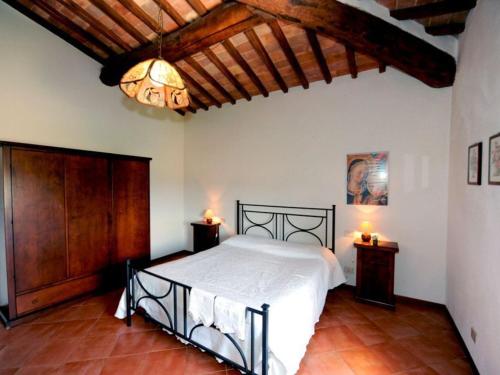 a bedroom with a bed and two night stands with lights at Agriturismo il Canneto in Casole dʼElsa