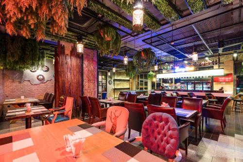 a restaurant with tables and chairs and a bar at SureStay Plus by Best Western T Pattaya in Pattaya
