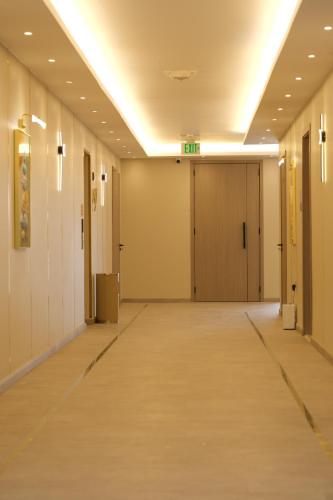 an empty hallway in a building with doors at AL MARSA HOTEL APARTMENTS in Khor Fakkan