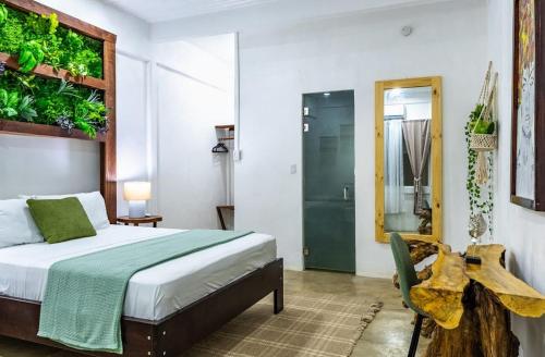 a bedroom with a bed and a plant wall at El Deseo Serendipity Tortuguero in Tortuguero