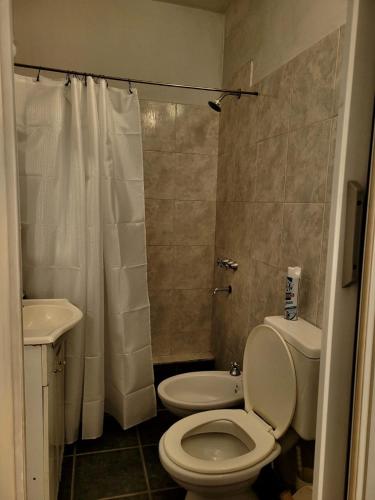 a small bathroom with a toilet and a sink at Zurita Apart in San Fernando del Valle de Catamarca