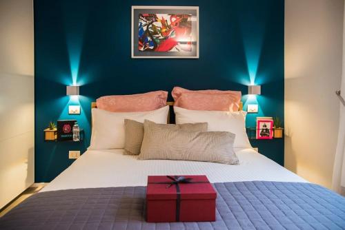 a bedroom with a bed with a red box on it at Luxury Boutique Apartment Milan in Milan