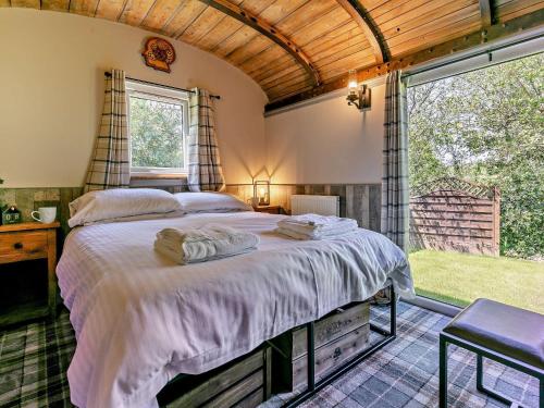 a bedroom with a bed and a large window at 1 Bed in Portreath 93858 in Redruth