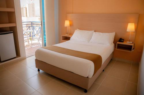 Postel nebo postele na pokoji v ubytování GIO Hotel Vajamar Valledupar