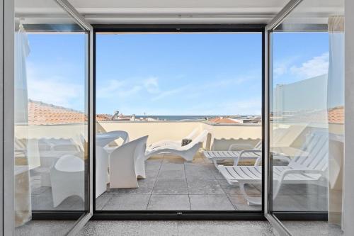 a view from the balcony of a house with sliding glass doors at GuestReady - Moledo's beach and sun in Santana