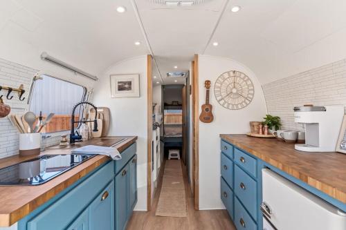a kitchen with blue cabinets and a sink at Desert Dream Airstream in Tombstone