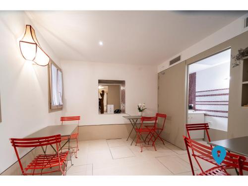 a dining room with red chairs and a table at TriplyRooms Collection - Venezia in Venice