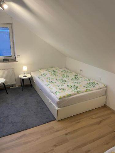 a bedroom with a bed with a flowery blanket at Gemütliche Dachgeschoss Wohnung in Selm