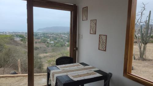 a room with a table and a large window at Le jardin in Puerto López