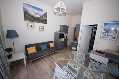 een woonkamer met een bank en een tafel bij Le 14 De Pic in Cauterets