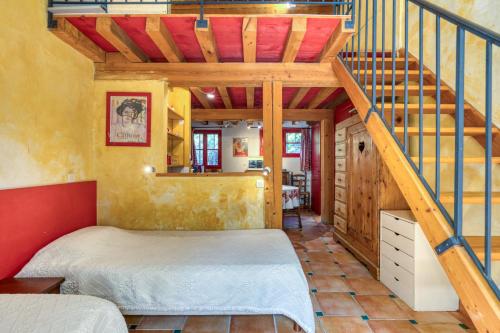 a bedroom with a bed and a staircase at Camoin in Fourques
