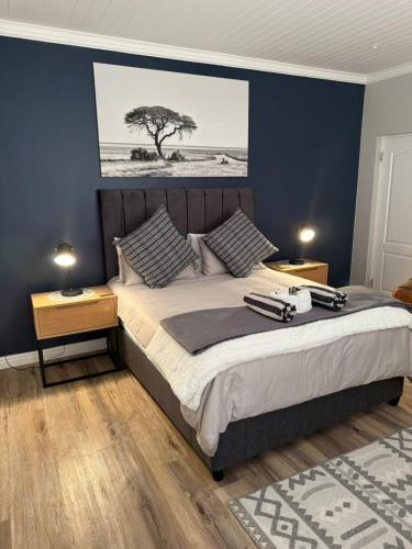 a bedroom with a large bed with two night stands at Yellow Wood 1 in Hermanus