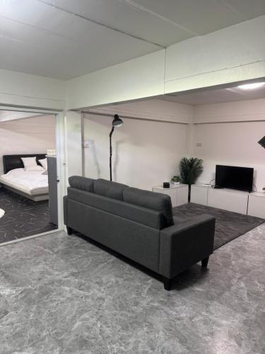 a living room with a couch and a bed at Chaota Modern House in Ban Ao Makham