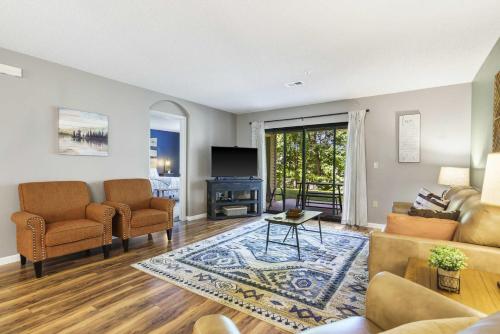 a living room with a couch and chairs and a television at Antler Ridge Retreat - 2 BDR in Branson
