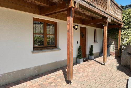 a porch of a house with a wooden roof at Ferienwohnung Kleines Wiesental in Kleines Wiesental