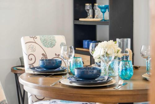 a dining room table with blue plates and glasses at Branson Sunny Daze - Sleeps 4 in Branson