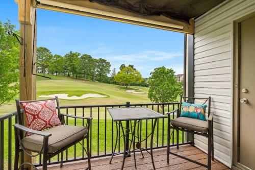 a balcony with a view of a golf course at Greenside Retreat - Pointe Royale in Branson