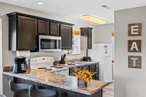 a kitchen with black cabinets and a counter top at Silver Lake Hideaway - Chic 2 BDR Dog Friendly in Branson
