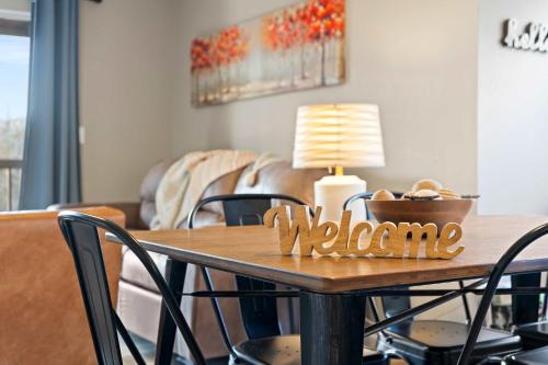 a dining room table with a welcome sign on it at Silver Lake Hideaway - Chic 2 BDR Dog Friendly in Branson
