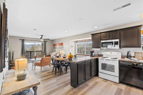 an open kitchen and dining room with a dining table at Silver Lake Hideaway - Chic 2 BDR Dog Friendly in Branson