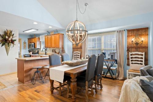 a dining room and kitchen with a table and chairs at Par 7 Penthouse at StoneBridge Resort in Branson West