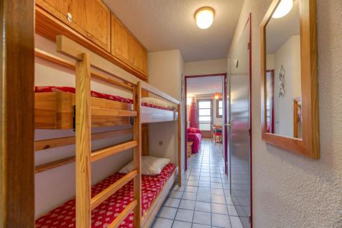 a room with three bunk beds and a hallway at Granges 8 - Bel Appt 4p Au Pied Des in Villard-Reculas