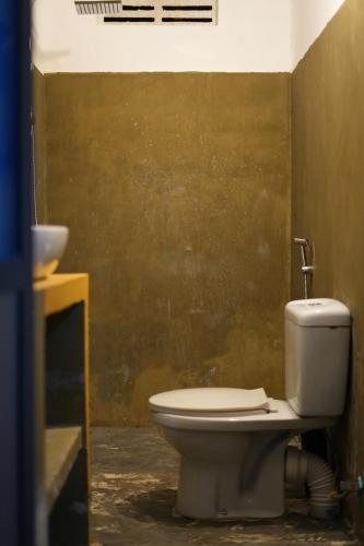 a bathroom with a toilet and a sink at Sri Vishwa Buddha MUni in Kalagedihena