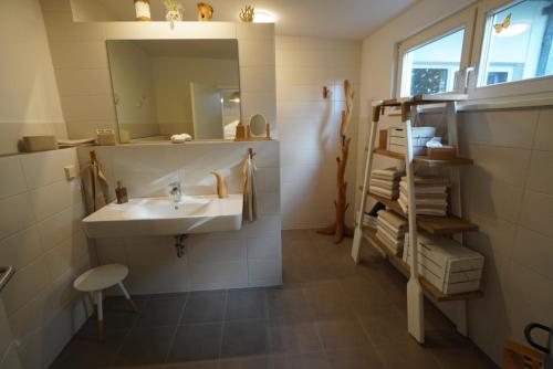 a bathroom with a sink and a mirror at Küstenloft-Leuchturm in Rostock