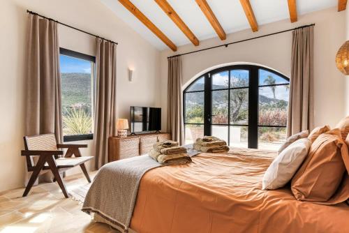 a bedroom with a large bed and a large window at Las Brisas in Jávea
