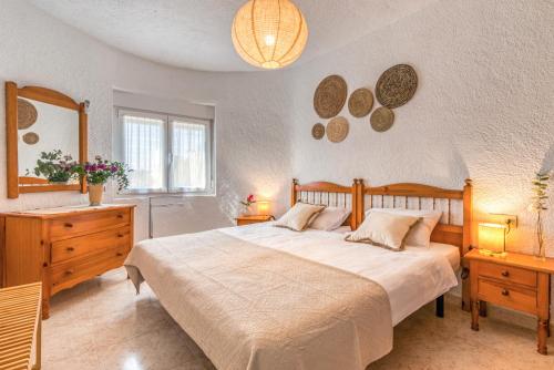 a bedroom with a large bed and a mirror at El Horreo Xabia in El Tosalet