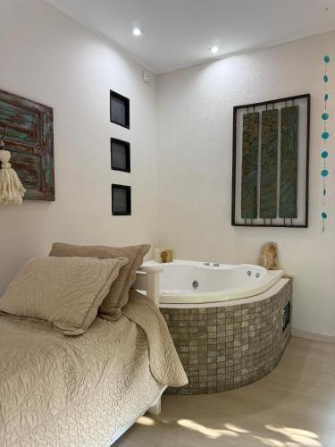 a bedroom with a bed and a bath tub at Sumergite en una gran piscina o jacuzzi in Gualeguaychú