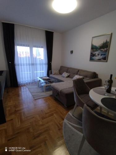a living room with a couch and a table at Apartment "Splendid J&R" in Bijeljina