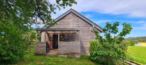 a small wooden church in a grassy field at Haus Freddy in Wallenfels