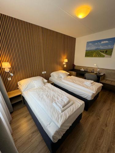 a hotel room with two beds in a room at Hotel ROSE Břeclav in Břeclav