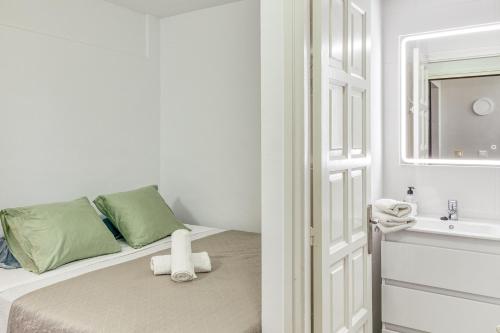 a bedroom with a bed with a sink and a mirror at Rio costa in Empuriabrava