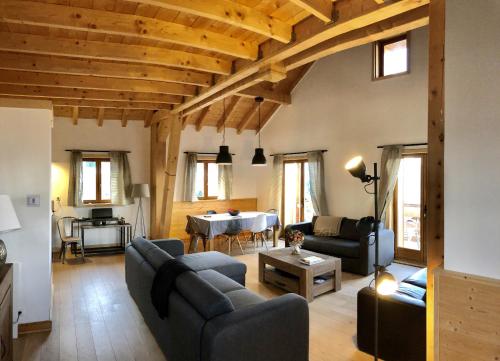 a living room with a couch and a table at Chalet 4 étoiles La Saulire in Villard-Reculas