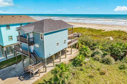 an aerial view of a blue house on the beach at Blue Waves - Beachside Calm, Gulf Views for Miles in Freeport