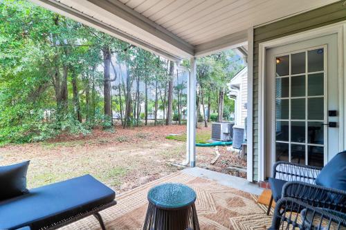 um alpendre com cadeiras e uma mesa em Boho Ferry- Mins from Credit One- Pet Friendly em Charleston