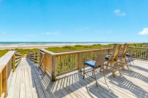 a deck with chairs and a view of the beach at Blue Waves - Beachside Calm, Gulf Views for Miles in Freeport