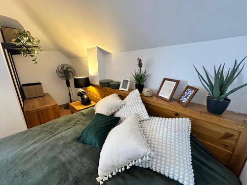 a bedroom with a bed with pillows on it at Murphys Lodge panorama apartment in Bansko