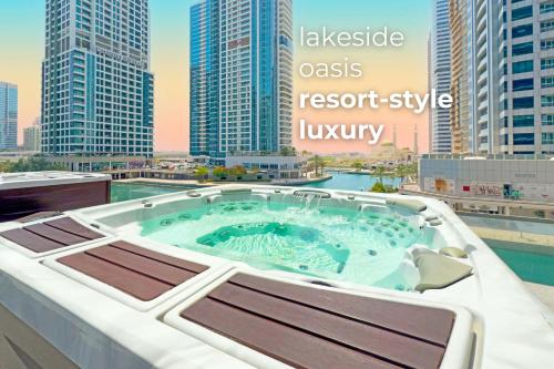 a hot tub on the roof of a building at SettlerHomes - Elegant JLT Lakefront Near Metro in Dubai