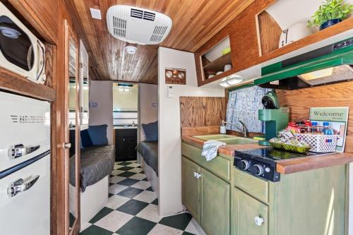 an rv kitchen with a checkered floor at SS Mindy - A Unique Tombstone Stay in Tombstone