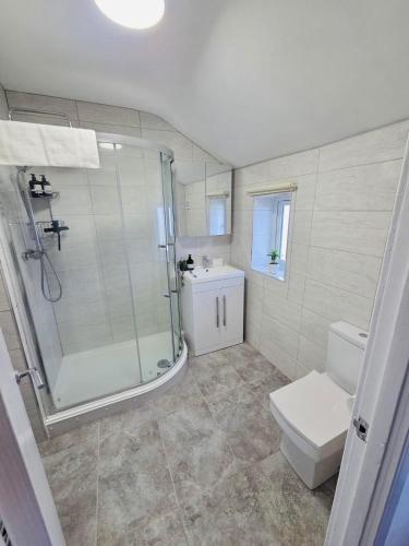 a bathroom with a shower and a toilet and a sink at 3 Bedroom Village Stay - Contractor and Professional Friendly Extended Stay Workspace in Kippax