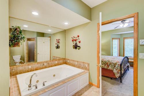 a bathroom with a tub and a bedroom with a bed at Chetola: Berkshires 3 in Blowing Rock
