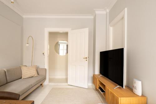 a living room with a couch and a flat screen tv at Amazing Apartment in Urban Neighborhood in Copenhagen