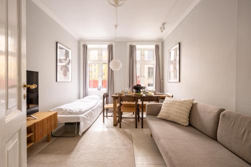 a living room with a couch and a table at Amazing Apartment in Urban Neighborhood in Copenhagen