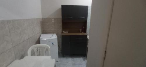 a small bathroom with a toilet and a sink at Residencial Barbosa - Apto 102 in Macaé