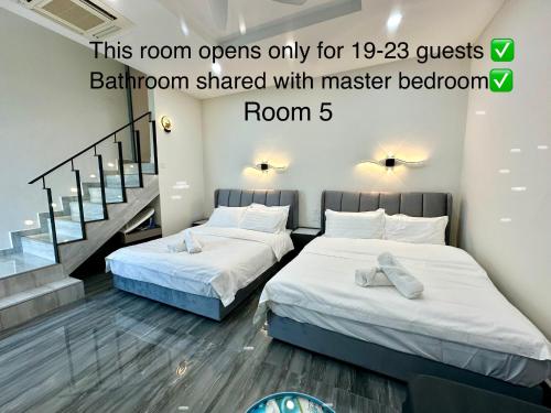 two beds in a room with a staircase at Stylish Villa Alma 18-23 Guests - Pool, KTV & BBQ in Simpang Ampat