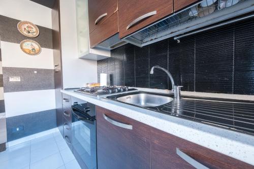 a kitchen with a sink and a stove at Casa Via Medici in Milazzo